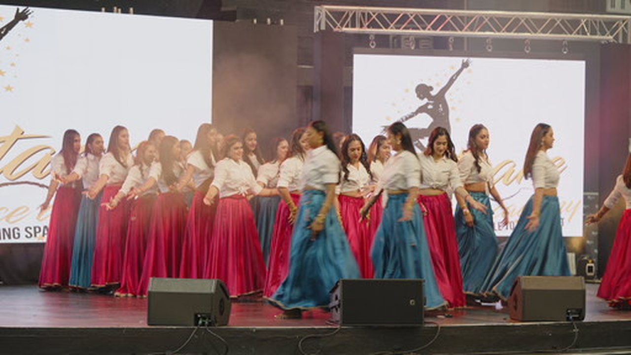 Group of performers in red and white traditional dress
